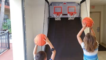 Enjoy a game of hoops on our indoor basketball court, featuring two hoops and a netted wall.
