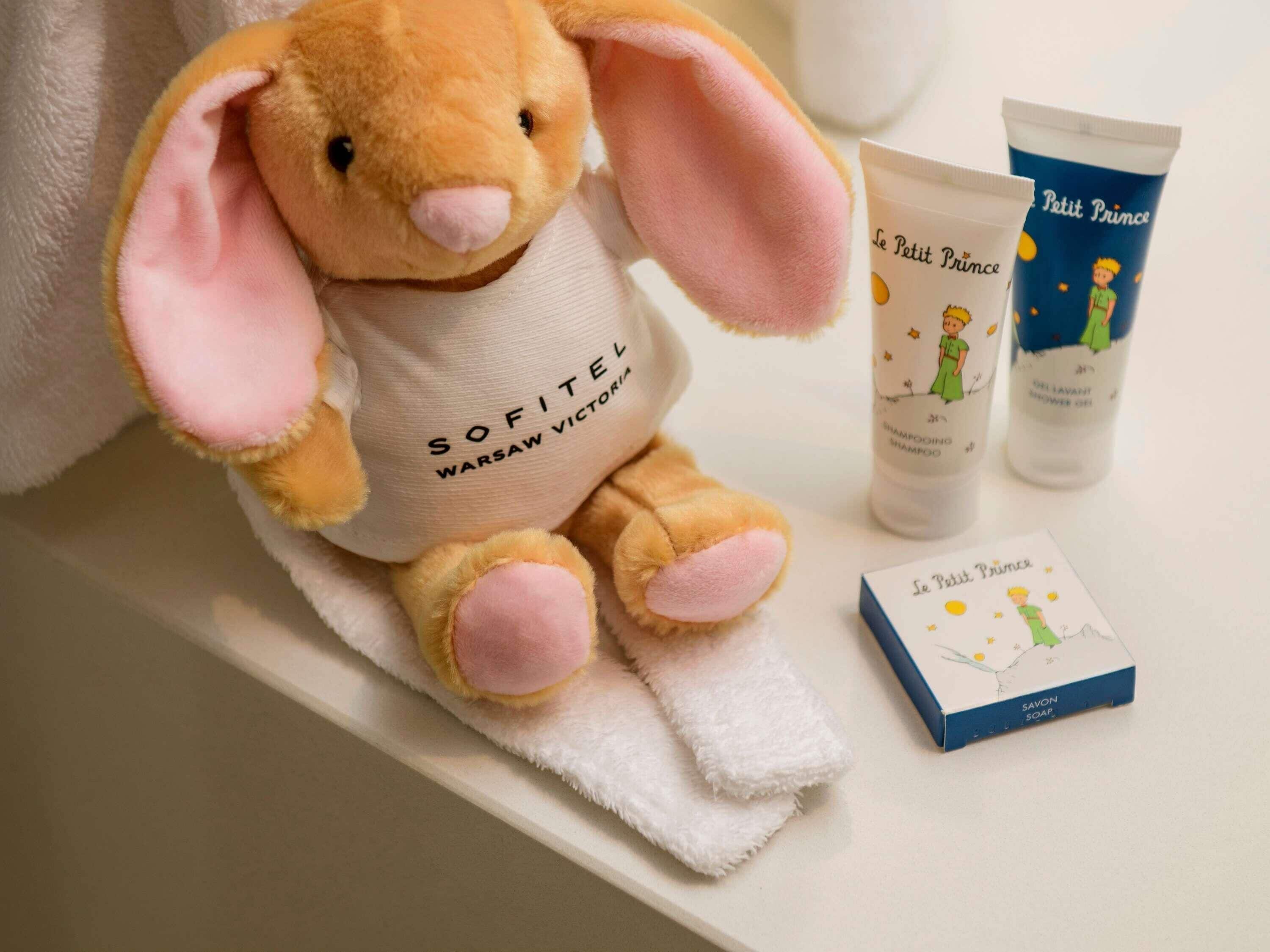A plush toy, toiletries, and a soap bar on a shelf.