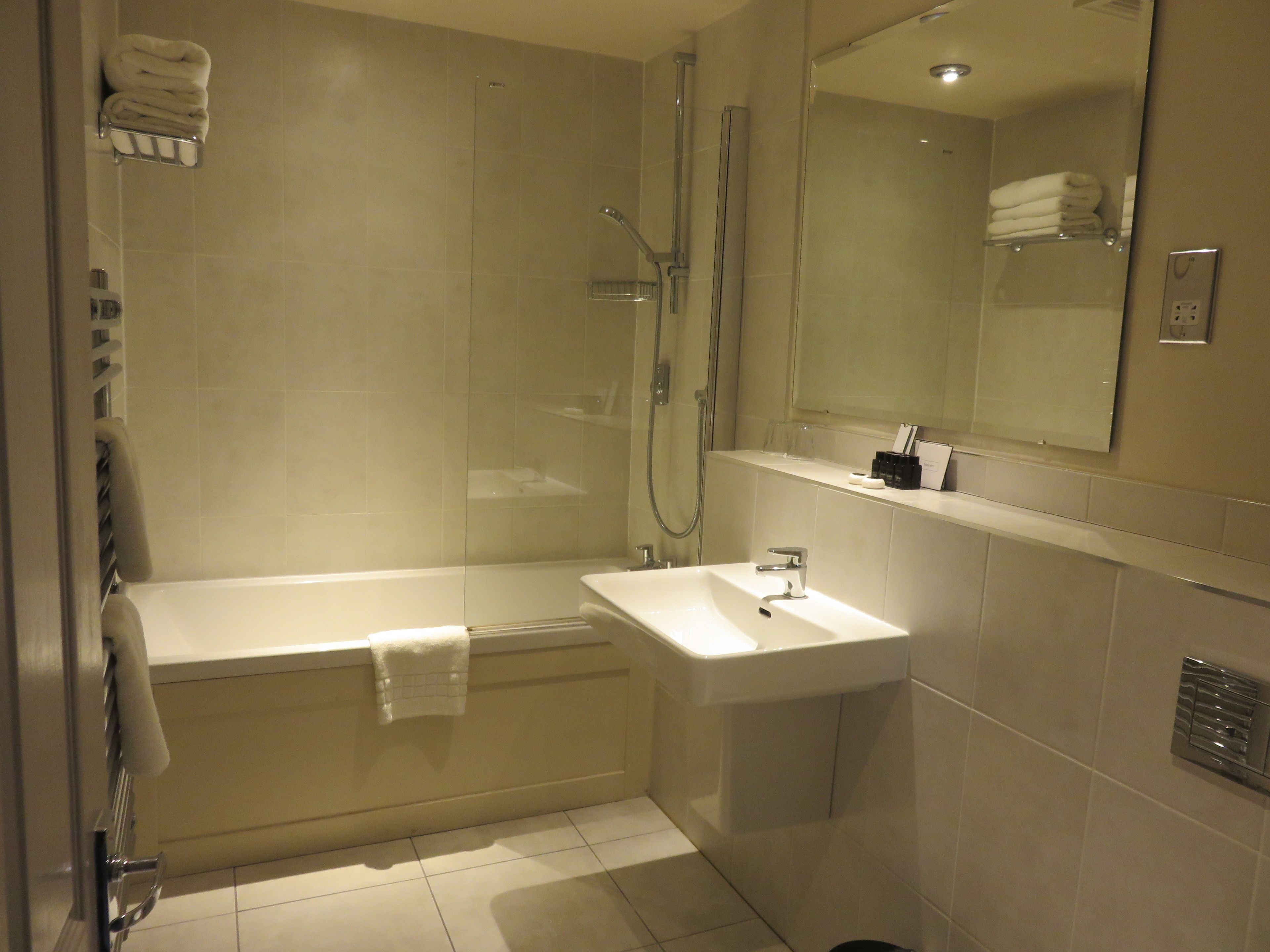A modern bathroom with a bathtub, a sink, and a shower.