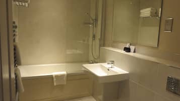 A modern bathroom with a bathtub, a sink, and a shower.