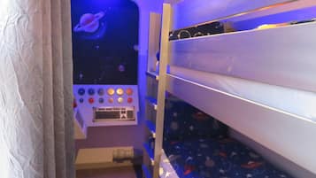 Cozy space-themed bedroom with a lower bunk bed and a wall-mounted control panel displaying a space scene.