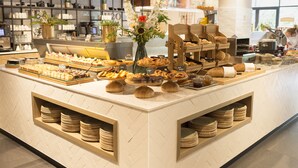 A buffet area with various food items and a coffee station. - Van der Valk Hotel Antwerpen (Antwerp)