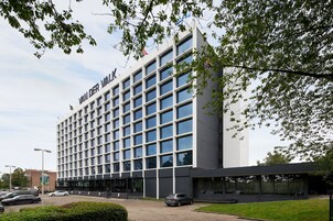 A modern building with a grid of windows and a sign reading "VAN DER VALK".