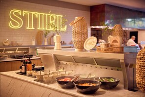 A breakfast buffet area with various food items and a sign that reads 'STIRL'. - Van der Valk Hotel Antwerpen (Antwerp)