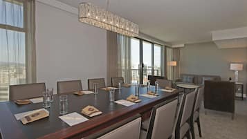 A conference room with a long table, chairs, and a chandelier.