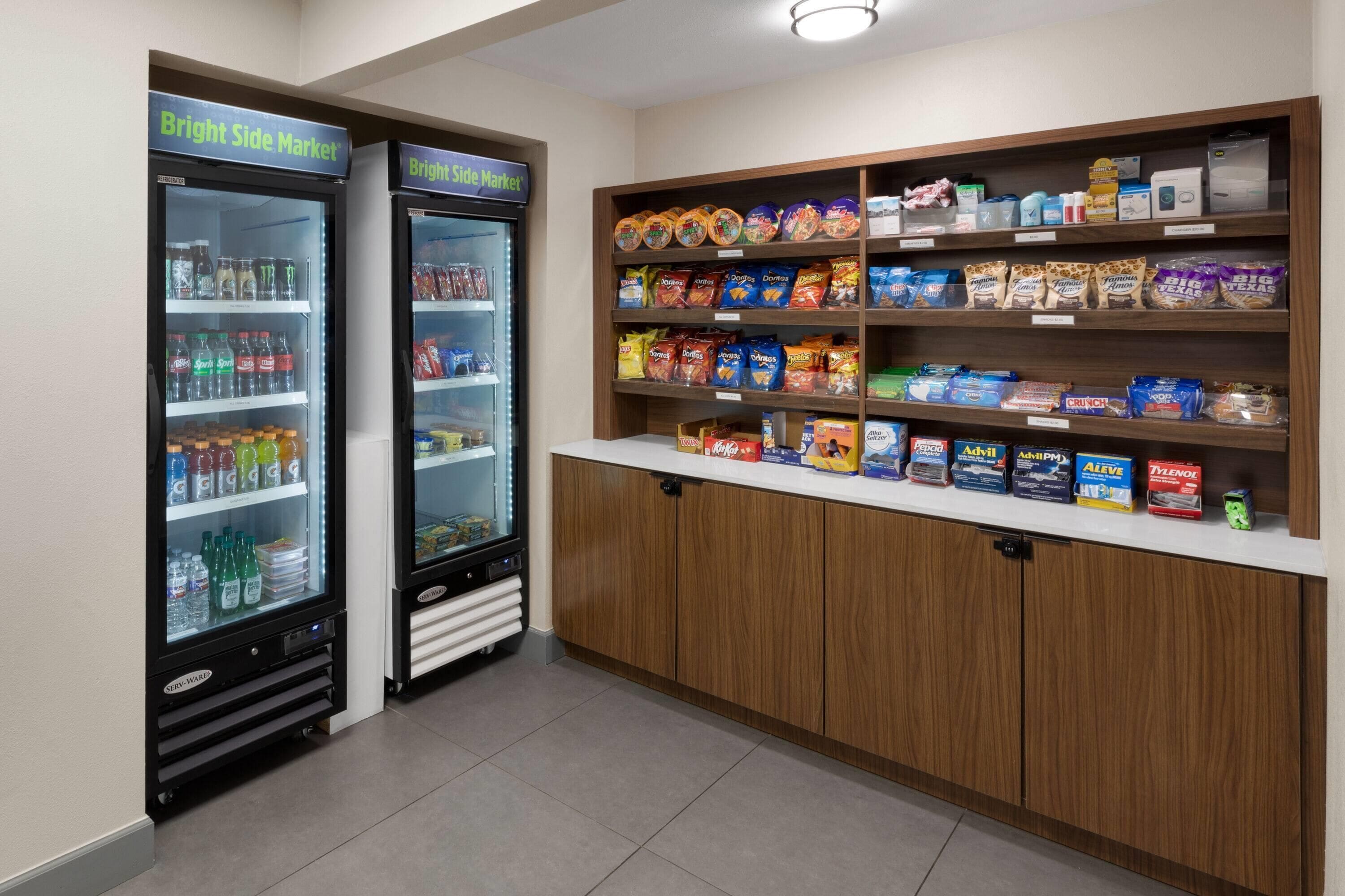 A Bright Side Market with refrigerated beverage dispensers and snack shelves.