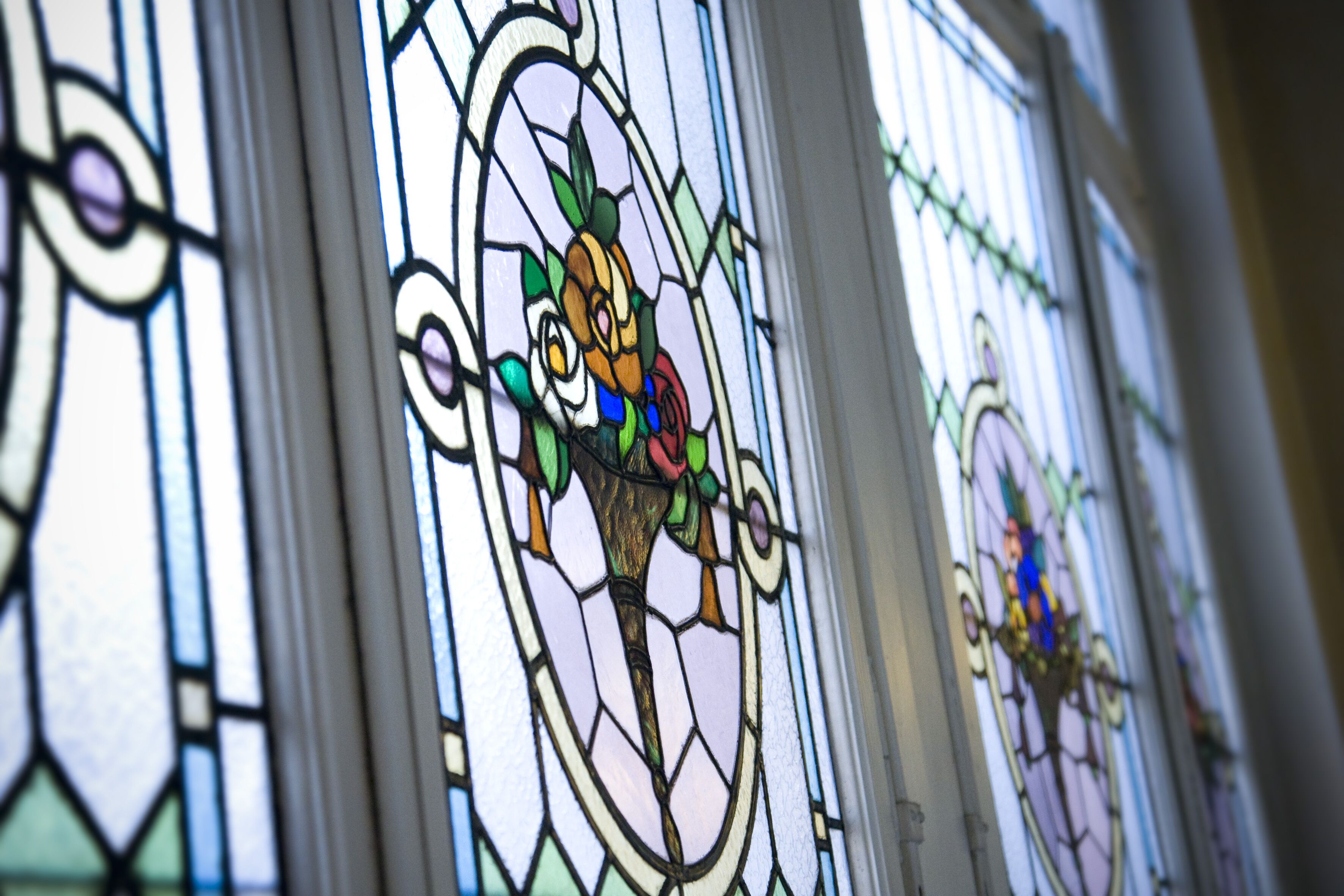 A stained glass window with floral designs.