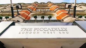 The entrance of The Piccadilly Hotel in London West End, featuring a prominent sign and classical architectural details. - Montcalm Piccadilly Townhouse, London West End (London)