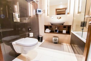 A modern bathroom with a toilet, sink, and shower.