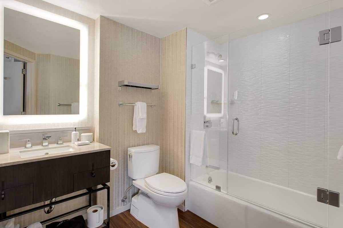 combined shower/bathtub, designer toiletries, hair dryer, bathrobes