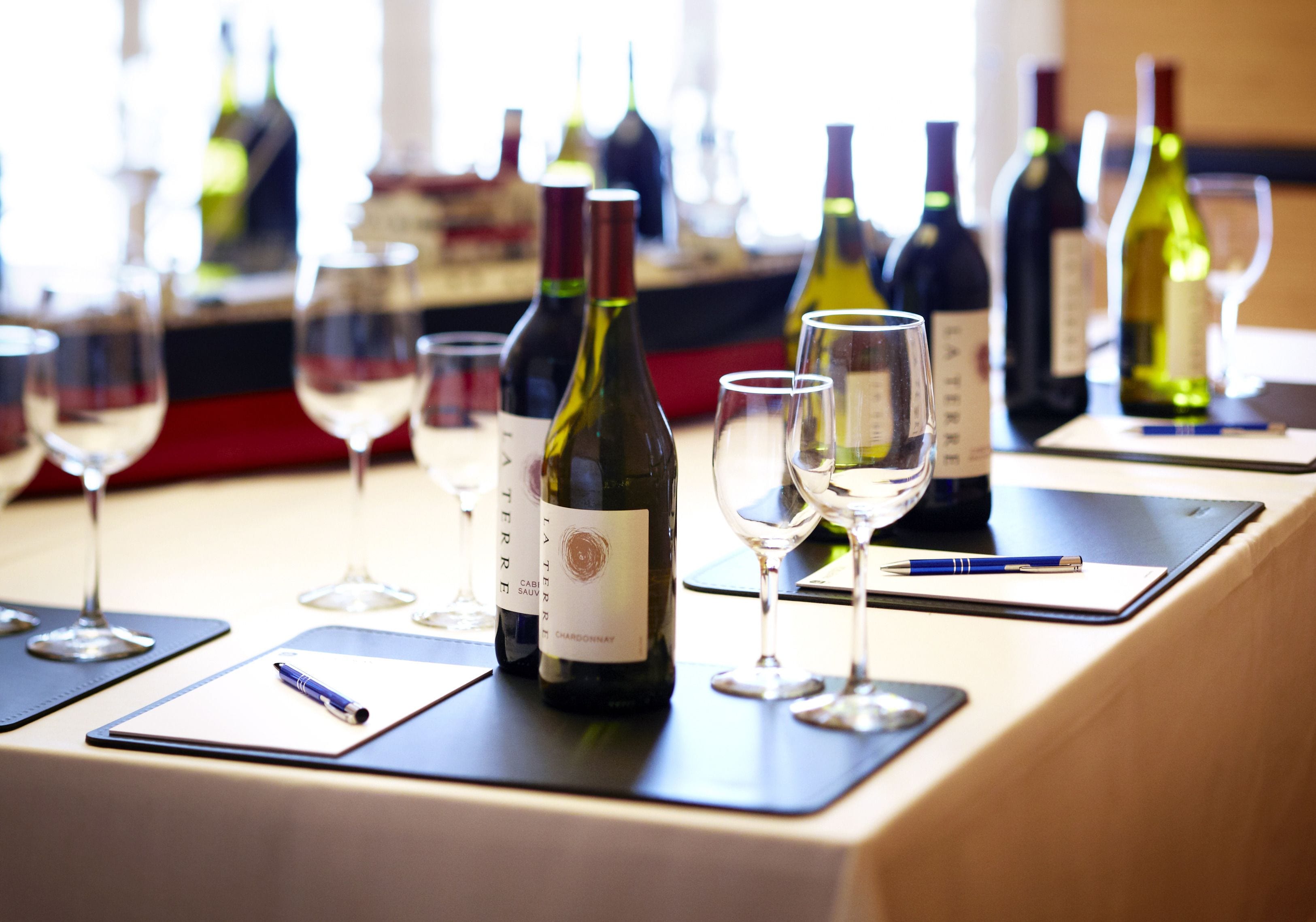 A table with wine bottles and glasses, suggesting a wine tasting event.