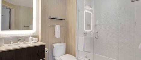 A modern bathroom with a vanity, toilet, and walk-in shower.
