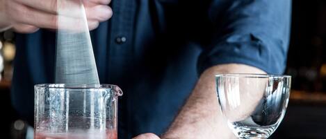 A person pouring a drink into a glass.
