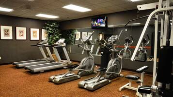A gym with treadmills, elliptical machines, and weight equipment.
