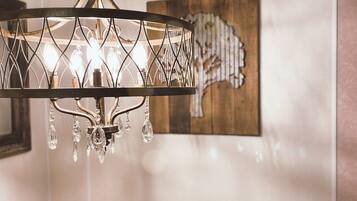 A chandelier with multiple bulbs and crystal decorations hanging from a metal frame.