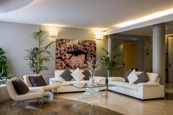 Relax in a stylish living area with a large cityscape artwork, comfortable sofa, and sleek coffee table.