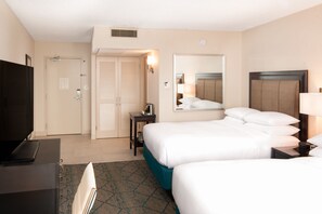 A hotel room with two beds, a desk, a TV, and a mirror. - Hilton San Diego Airport/Harbor Island (San Diego)