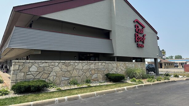 A building with a stone facade and a large awning.