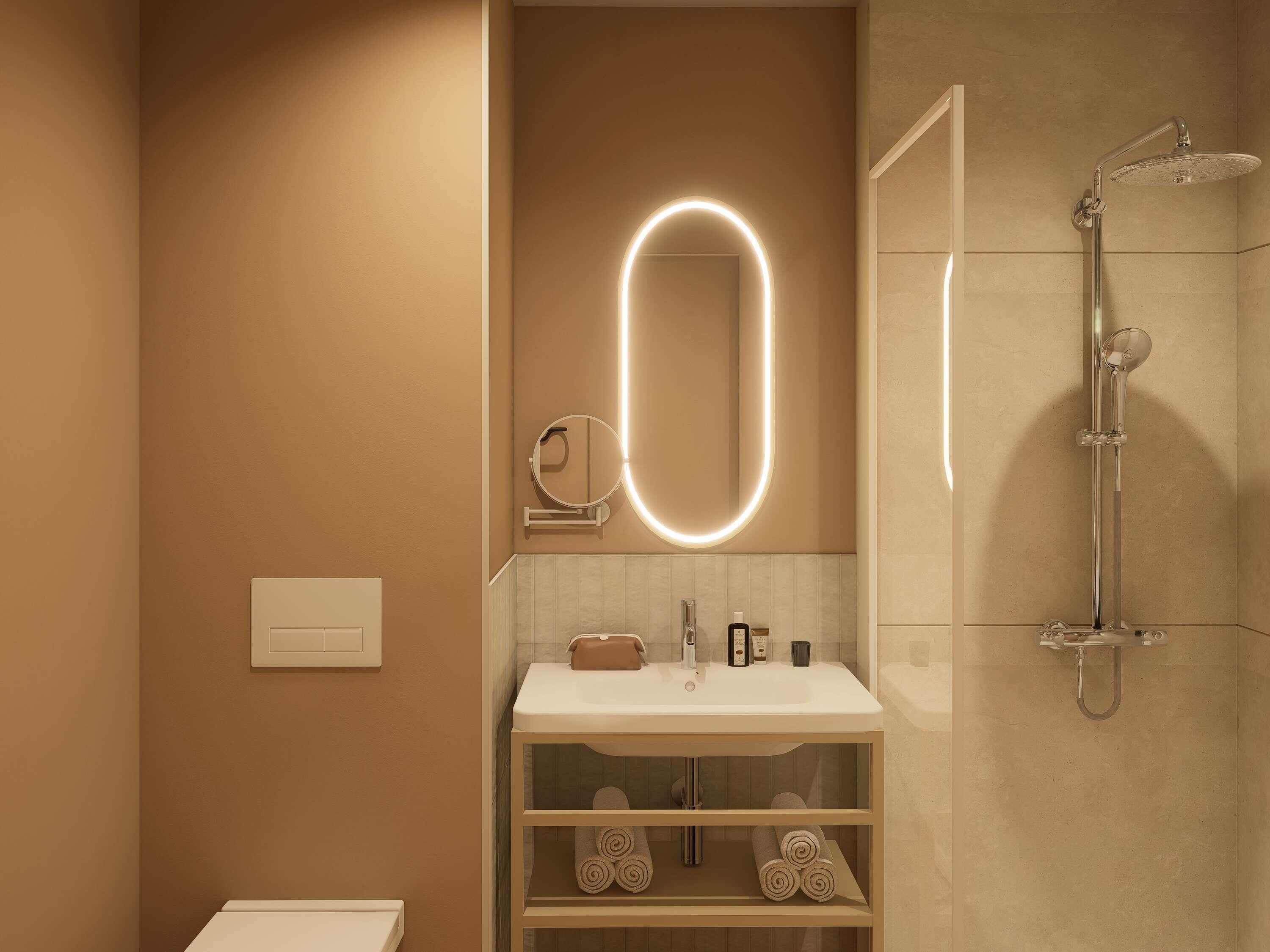 A modern bathroom with a vanity, a shower, and a wall-mounted mirror with illuminated oval lights.