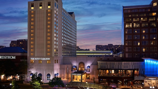 A hotel with a prominent entrance, multiple floors, and a modern architectural design.