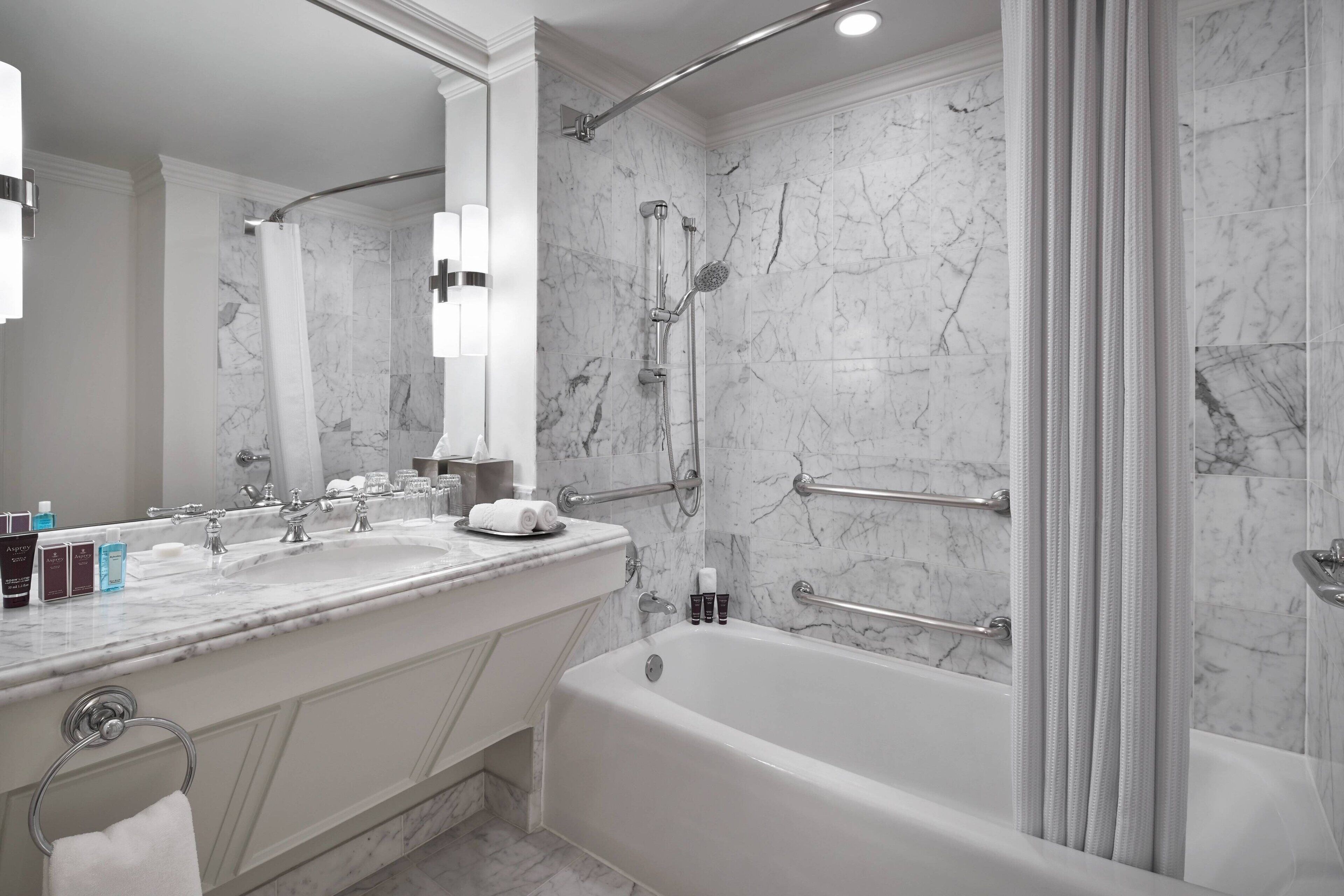 combined shower/bathtub, designer toiletries, hair dryer, bathrobes