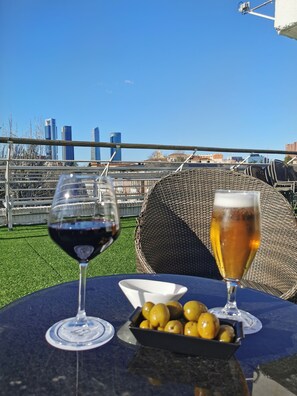Enjoy a casual rooftop dining experience with a view of the city skyline.