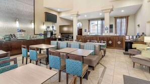 A hotel lobby with seating areas, a reception desk, and a kitchen in the background. - Best Western Oxnard Inn (Oxnard)