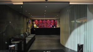 A hotel lobby with a reception desk, a sofa, and a carpet with the hotel name. - Hotel El Ejecutivo by Reforma Avenue (Mexico City)