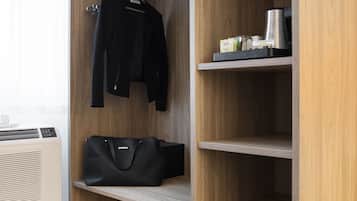 Un dressing accessible sans porte, avec des étagères en bois, une tringle à vêtements et une paire d’escarpins rouges posée sur le sol.