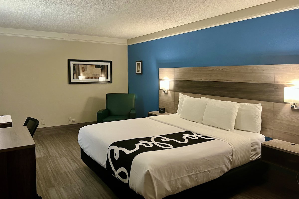 Premium bedding, desk, laptop workspace, iron/ironing board
