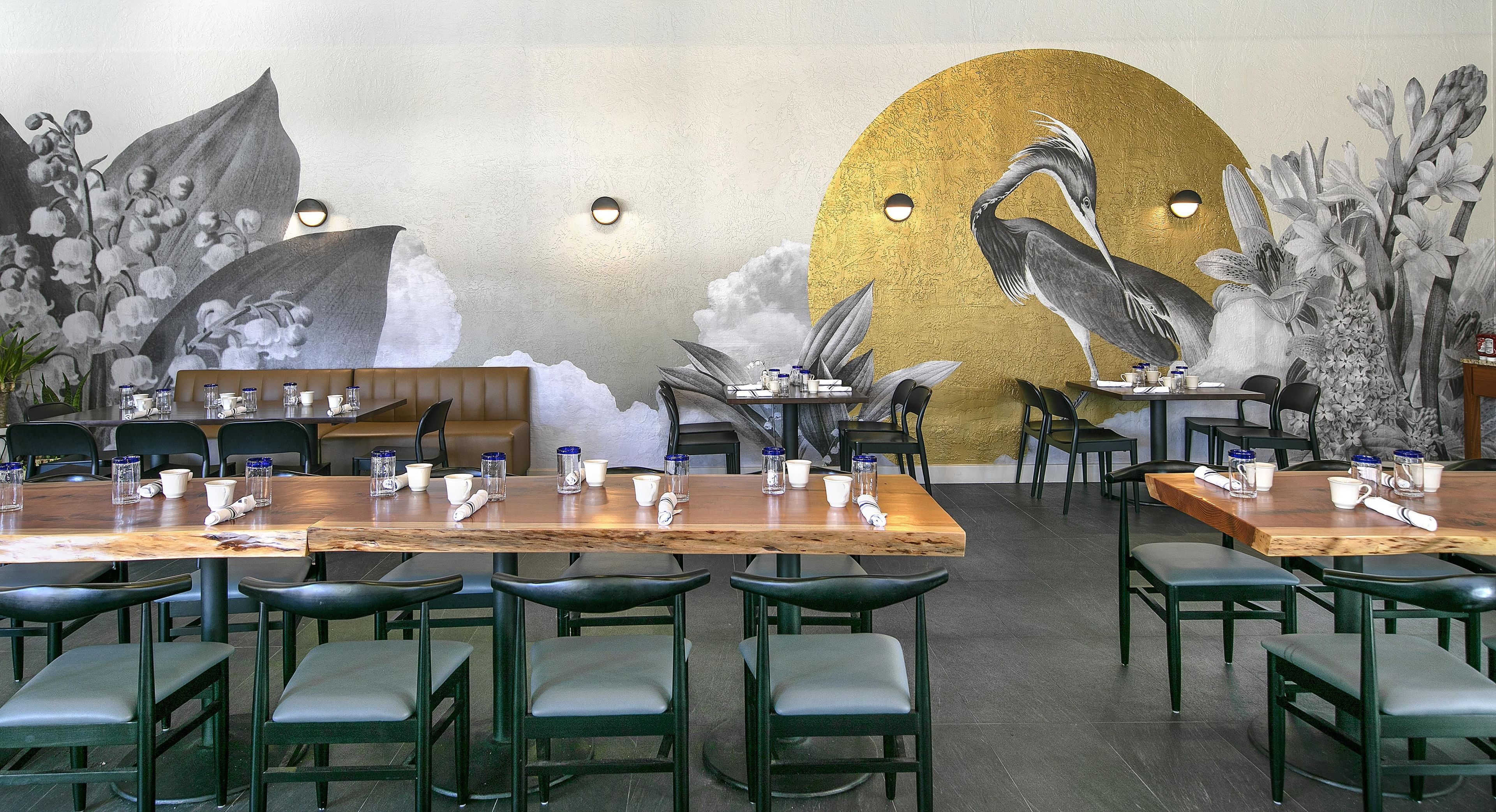 A restaurant interior with booths, tables, and chairs.