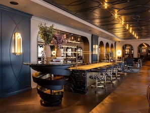 A modern bar area with a central bar, seating, and a decorative plant. - Mercure Tokyo Hibiya (Tokyo)