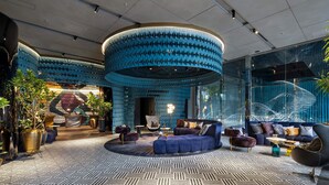 A modern lounge area with a circular ceiling design, plush seating, and a patterned floor. - Mercure Tokyo Hibiya (Tokyo)