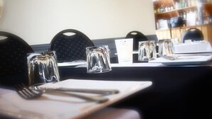 A table set with clear glasses, cutlery, and a menu. - Best Western Burnie Murchison Lodge (Somerset)