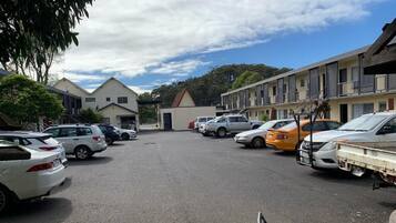 Guests can park their vehicles in the convenient parking lot adjacent to the motel's single-story buildings.