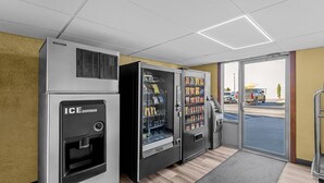 A vending area with an ice dispenser and snack vending machines.