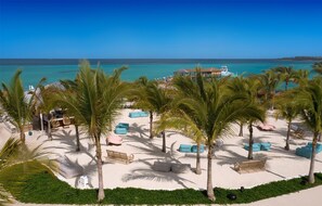 On the beach, white sand, sun loungers, beach umbrellas