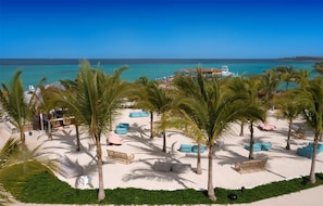 On the beach, white sand, sun loungers, beach umbrellas