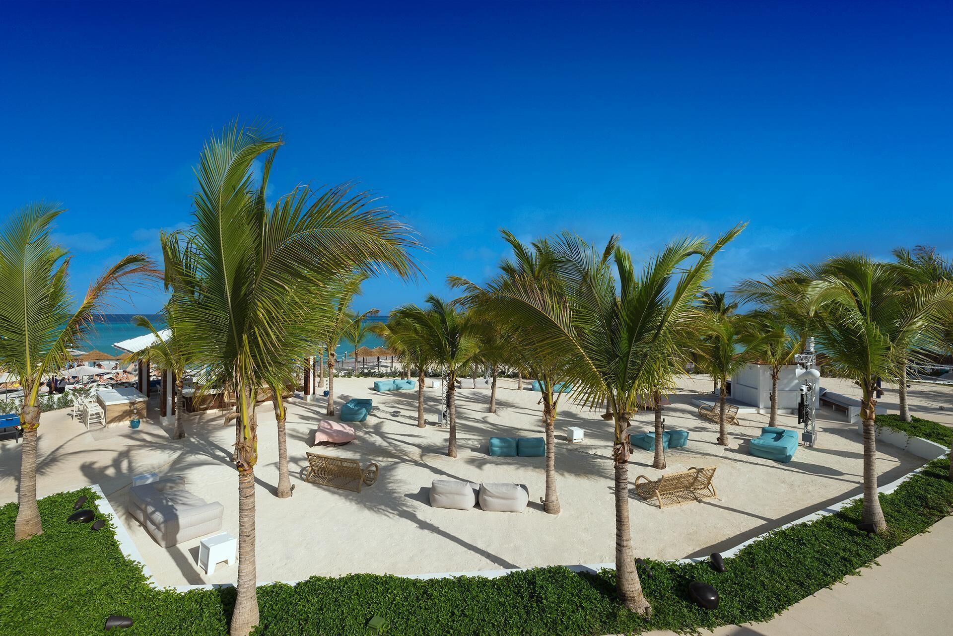 On the beach, white sand, sun loungers, beach umbrellas