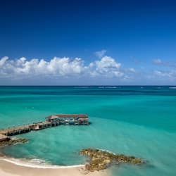 On the beach, white sand, sun loungers, beach umbrellas