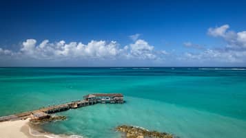 On the beach, white sand, sun loungers, beach umbrellas