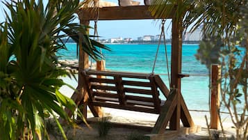 On the beach, white sand, sun-loungers, beach umbrellas