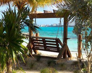On the beach, white sand, sun loungers, beach umbrellas