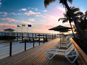 On the beach, white sand, sun loungers, beach umbrellas