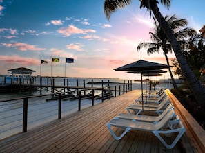 On the beach, white sand, sun loungers, beach umbrellas