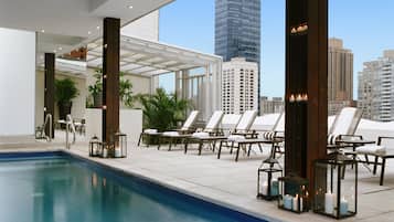 Seasonal outdoor pool, open 11:00 AM to 7:00 PM, pool umbrellas