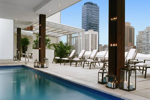 Seasonal outdoor pool, open 11:00 AM to 7:00 PM, pool umbrellas