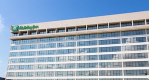 A multi-story building with a prominent 'Holiday Inn' sign at the top.