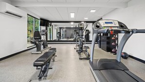 A gym with a treadmill, elliptical, and weight machines. - La Quinta Inn & Suites by Wyndham Sturbridge (Fiskdale)