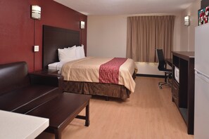 A hotel room with a bed, a desk, a chair, a television, and a wardrobe. - Red Roof Inn Van Horn (Van Horn)
